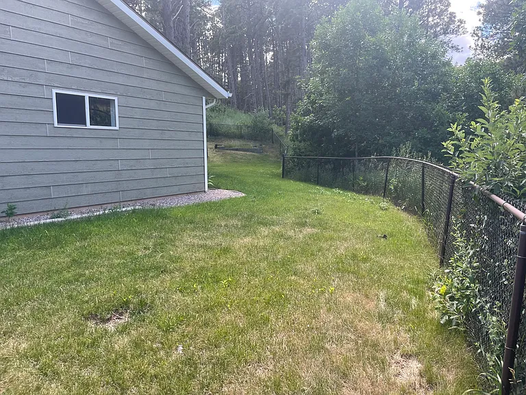 Yard area on side of garage.