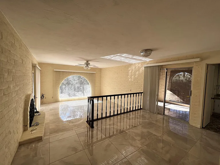 Main Bedroom with large walk-in closet, sliding door to back patio, fireplace, sliding door to interior patio and large bathroom.
