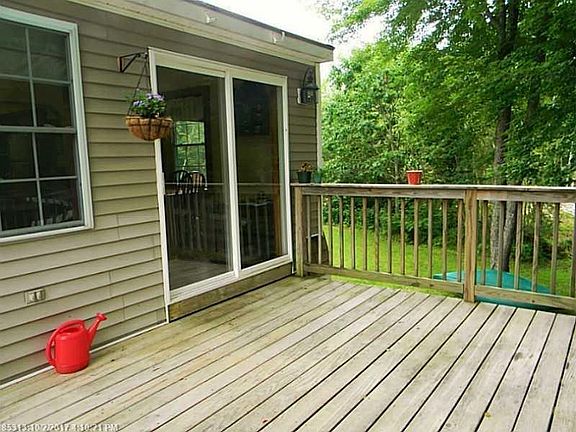 Direct access to deck from sliders off dining area.  (older photo shows open deck)