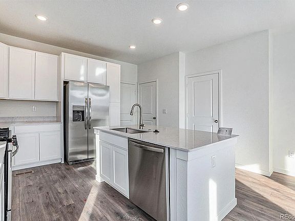 Kitchen with upgraded refrigerator, gas oven and range, and dishwasher