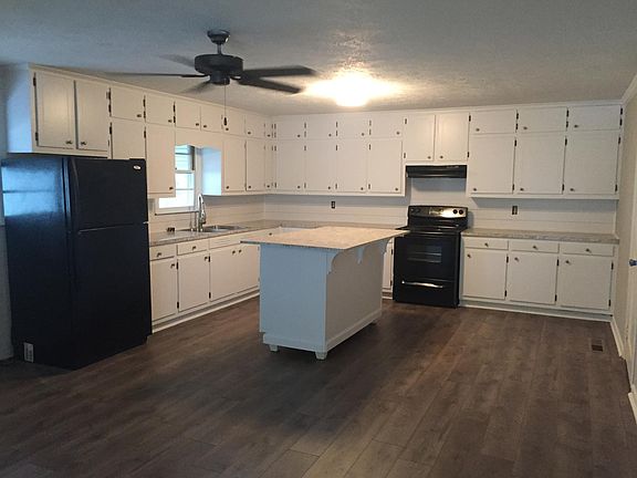 Spacious eat in kitchen with cabinets galore. Island with b