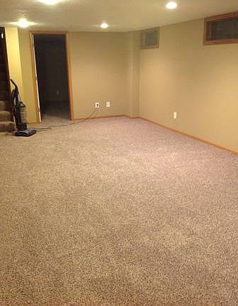 Family room in lower level with can lights and new carpet.