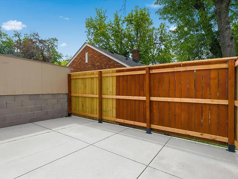 New concrete patio with privacy fence.