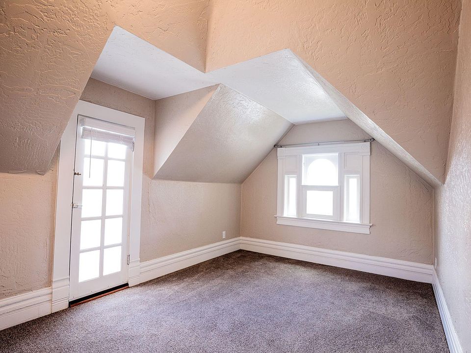 Lofty dormer space with a Juliette balcony facing West.