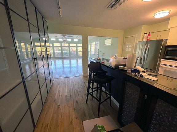 floor to ceiling closed cabinets across from the kitchen