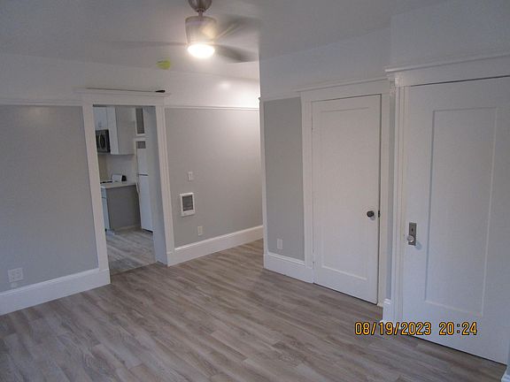 Living Space looking into Kitchen and front door entry hall. Doors to closet and bath on the right.