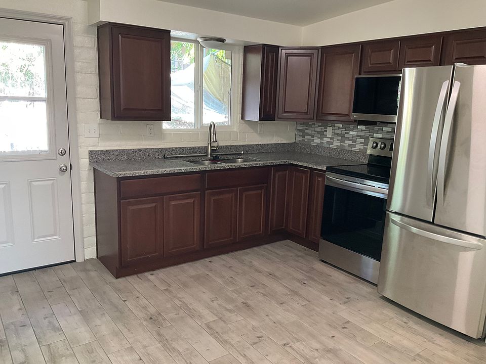 Kitchen with door to walled patio