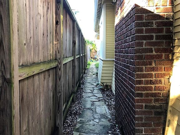 This is the walkway from the front gate that leads you to the 2 garage apartments at the rear of this property.