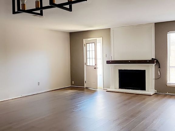 Living Room with a Wood fireplace, Back door to car port