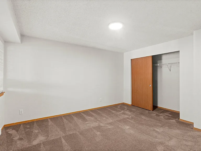 Step into comfort with this spacious room, featuring a practical closet space and soft carpeted floors. Step into comfort with this spacious room, featuring a practical closet space and soft carpeted floors.
