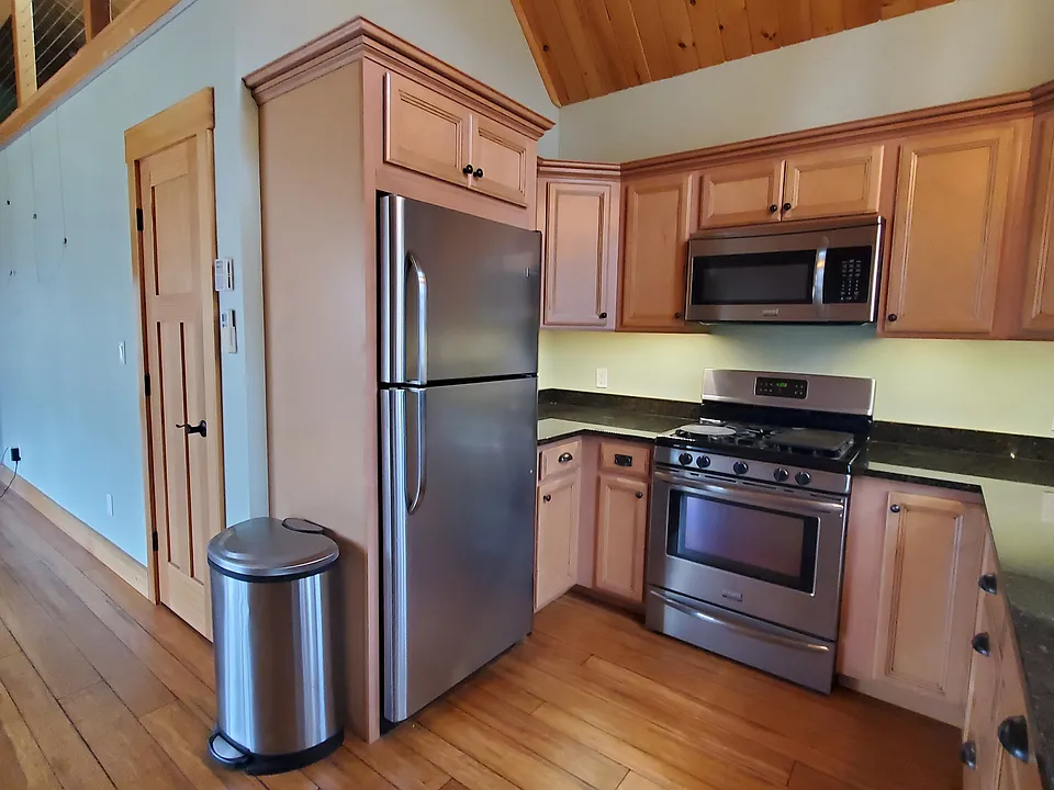 The kitchen with granite counters, ample cabinets and a pantry closet also has a built-in desk with 2 file drawers.