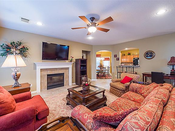 Den also features a fireplace and recessed lighting