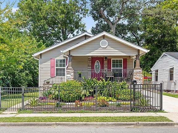 Front view with partial fence and side parking.