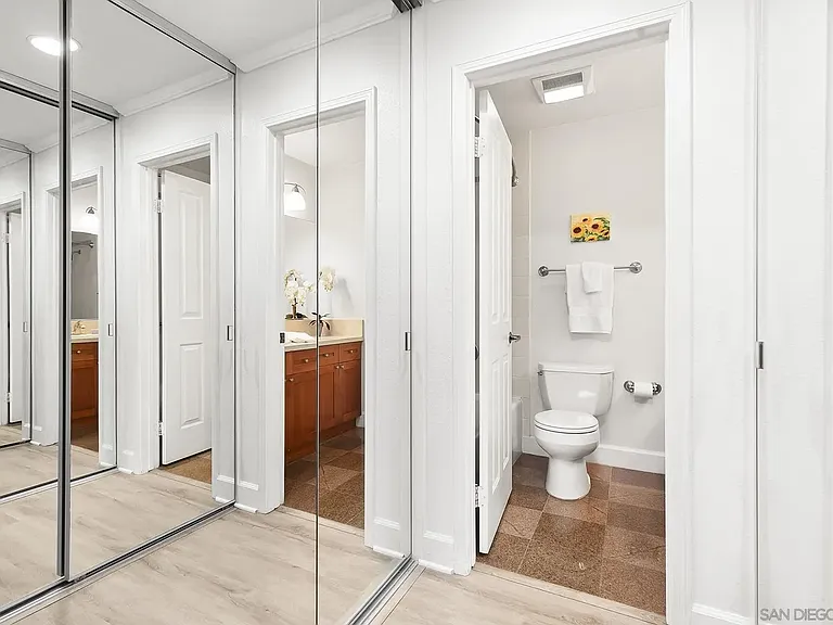 Two mirrored closets in dressing area.