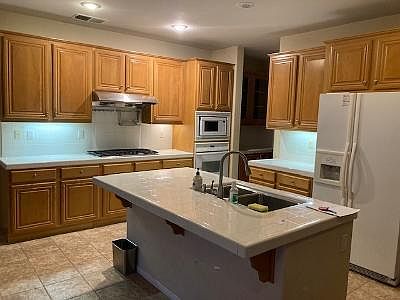Downstairs open kitchen area adjacent to fireplace area and backyard