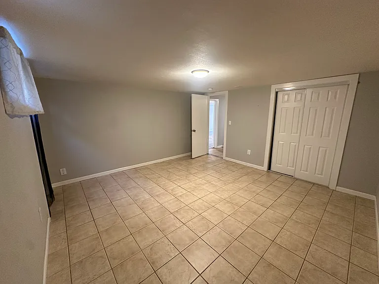 5th bedroom with exterior door to backyard