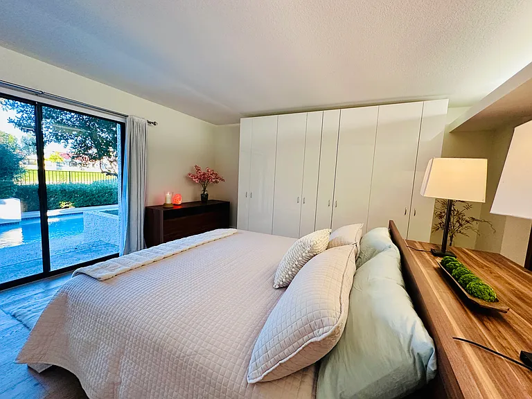 Master bedroom with big glass doors stepping directly out to the backyard