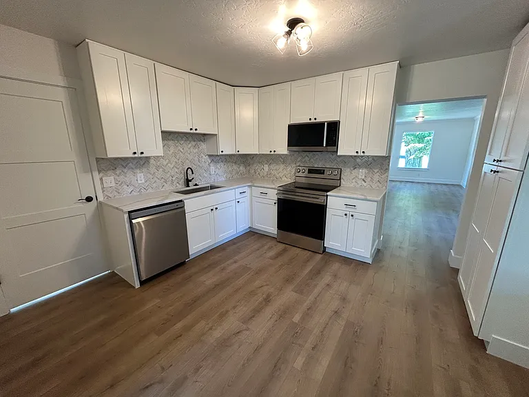 Kitchen (all new appliances including dishwasher, sink, oven, microwave and fridge, cabinets, backsplash, floors, fixtures)
