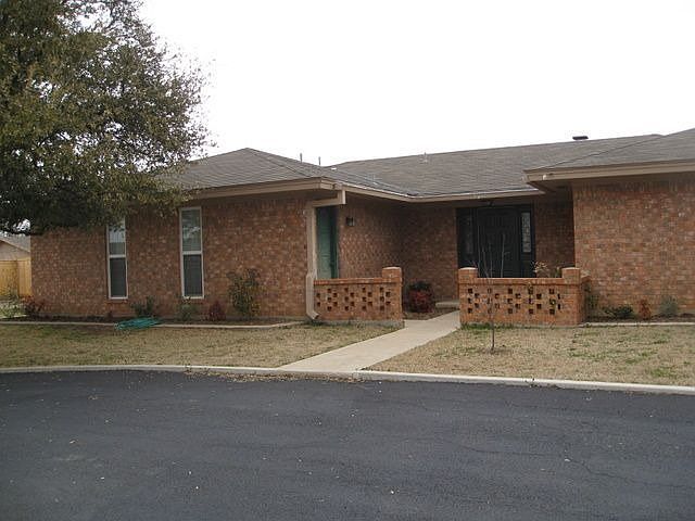 Front view of home with circle drive.