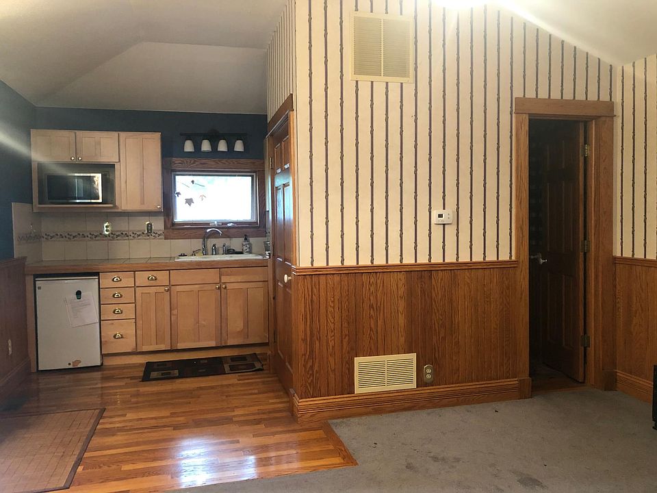 Kitchen area with door to a full bathroom. Facing west.