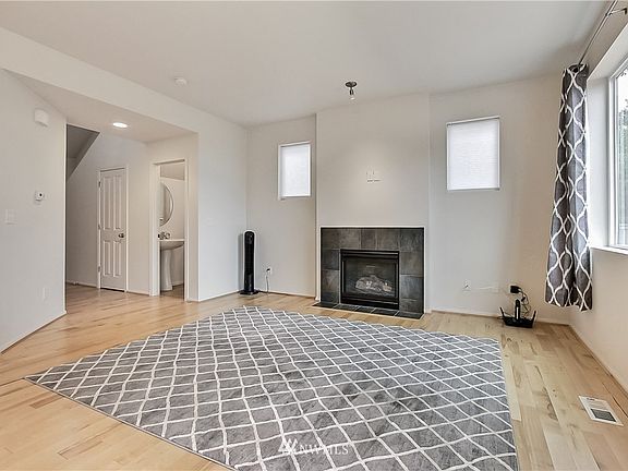 View of family room with gas fireplace, entry to your left, coat closet, powder room. 