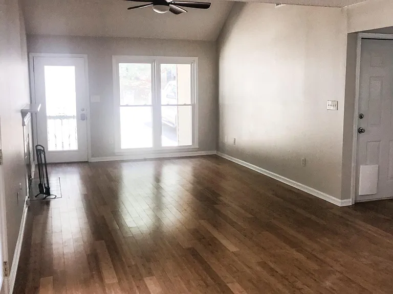 View of living room and door to garage from the dining area.
