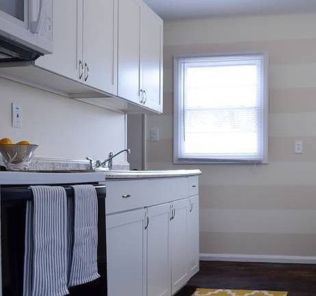 Renovated galley style kitchen (12x8) features brand new white cabinets and laminate counter tops, r