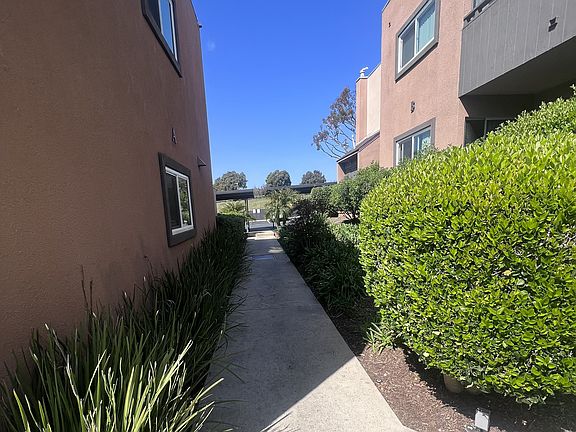 Walkway between apartment buildings at Villa Pacific Apartments in Oceanside, California.