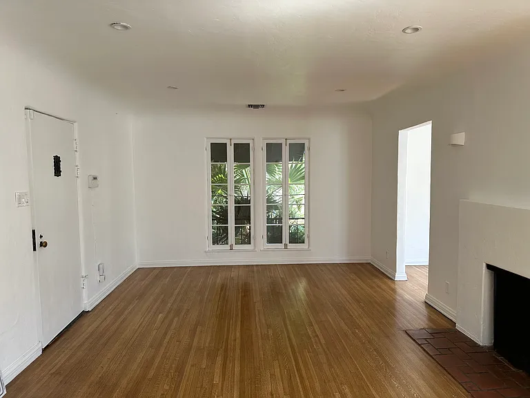 Living room with French windows & wood burning fireplace
