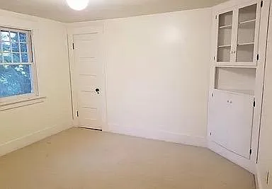 Third upstairs bedroom with built in closets and view to side yard