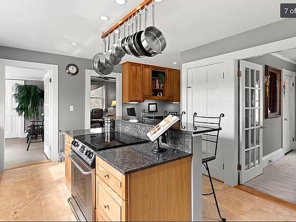 Mud room and den off kitchen, two entries to side yards east and west, view into dining room