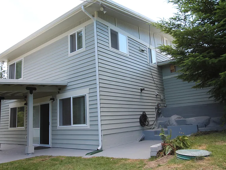 Back of house with covered patio.
