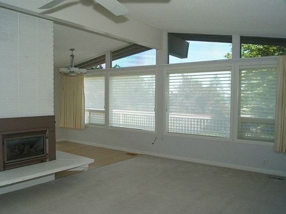 The west facing living room has a gas fireplace, air conditioning, new paint plus views of the Olymp