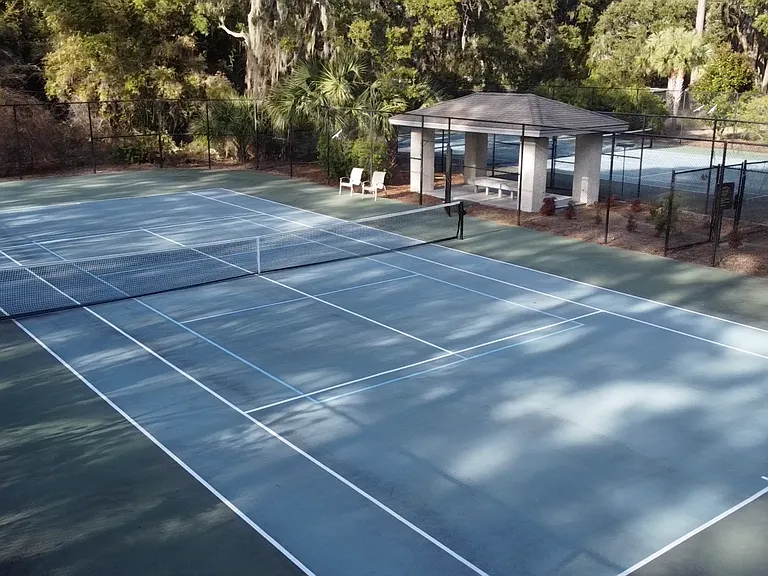 Stay active and entertained with exclusive access to Lake Forest's private tennis and pickleball courts, plus a sparkling community pool surrounded by palm trees and lush greenery.