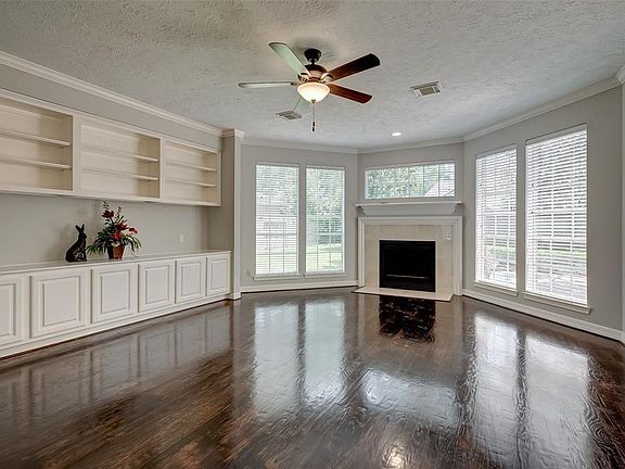 Entertaining will be a true delight! Enjoy the open space complimented with picturesque views of the tropical landscaping and extended patio out back. Great storage with built in cabinets and shelving. Recently refinished hardwood flooring.
