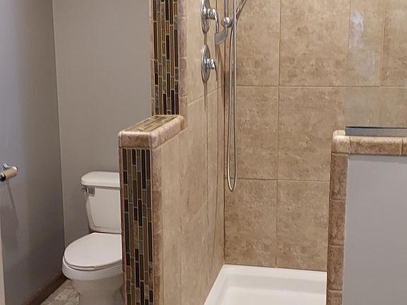 Master bath with large walkin tiled shower with 2 showerheads including overhead rain shower head.