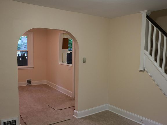 Living room looking into dining / kitchen area.