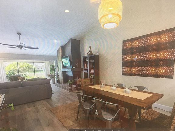 ******All photos are before the villa was purchased. The villa is not furnished.***** Looking into dining room and family room. New wood like porcelain tile.