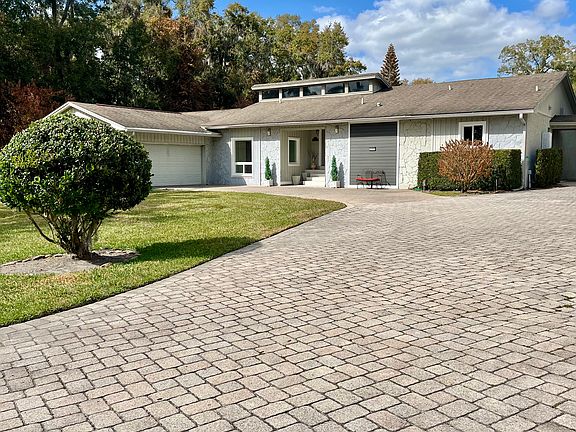 Long paved driveway leading to the front door and into the 2 car attached garage