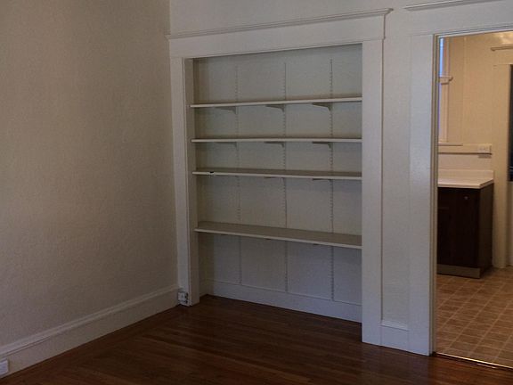 Living room shelves and doorway to kitchen.