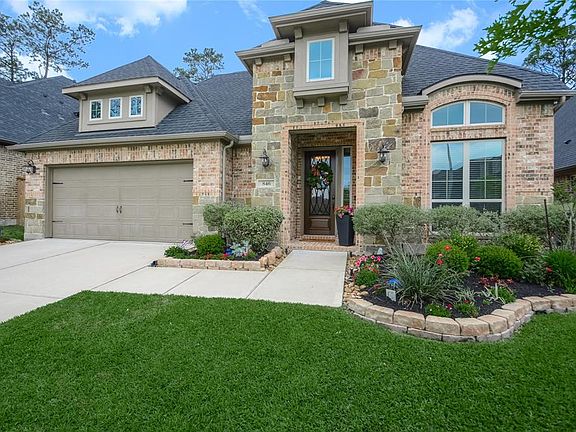Cheerfully updated landscaping graces the walkway to your covered front entry.