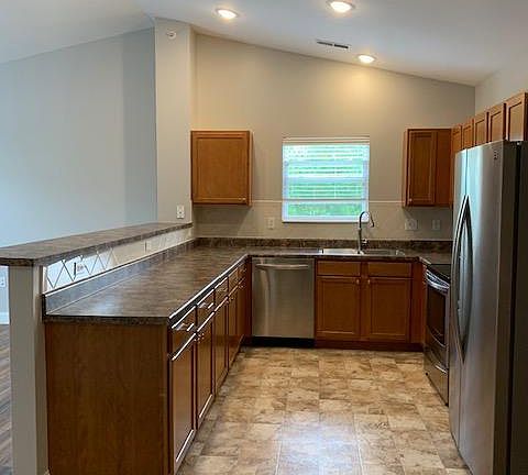 Awesome kitchen with stainless steel appliances and tree line view!