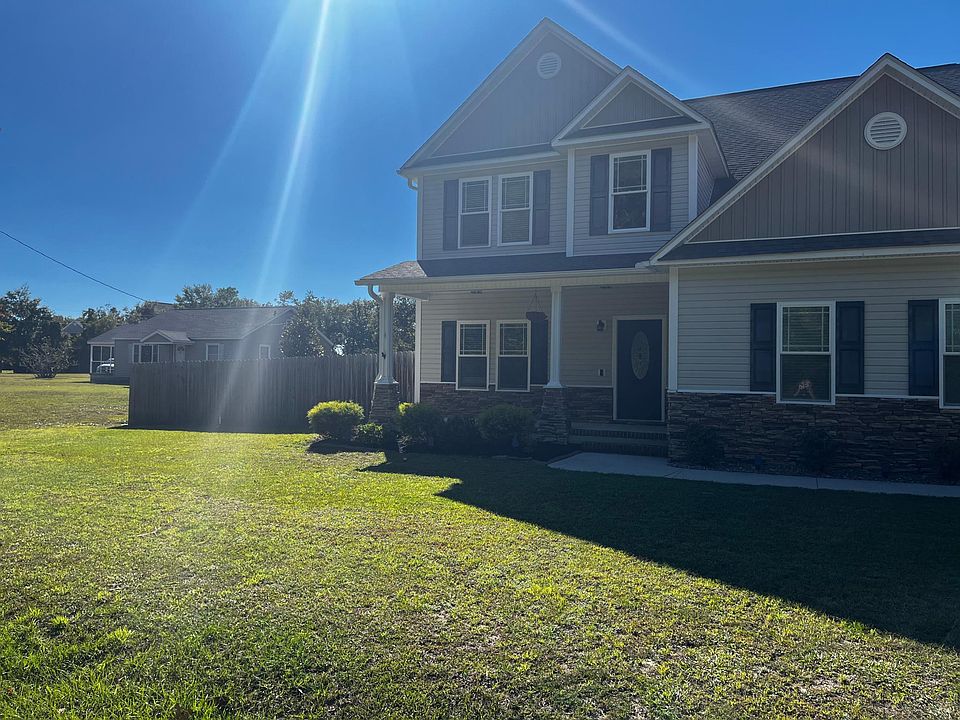 Inviting two-story home with a spacious front yard and covered entry.