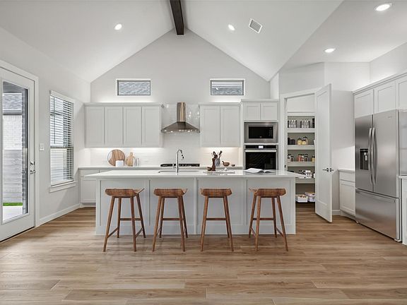 Kitchen with quartz countetops, stainless steel appliances and spacious pantry