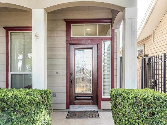 The richly stained leaded glass front door allows light to flood the entry making the entrance of this home feel especially welcoming.