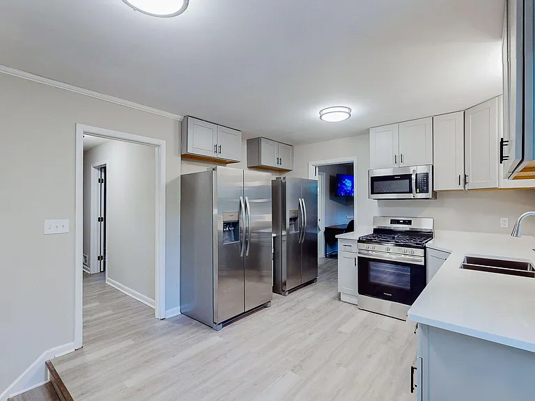 Updated kitchen with ample shaker cabinetry, stainless steel appliances, and generous counter space for everyday cooking.