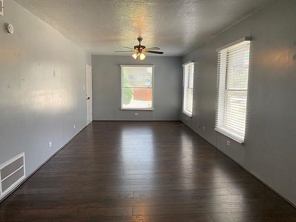Living and dining room with hardwood floors and lots of natural light