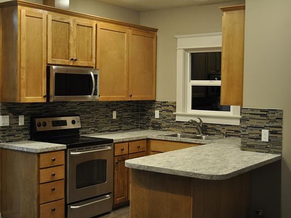 kitchen with dishwasher, stove, microwave