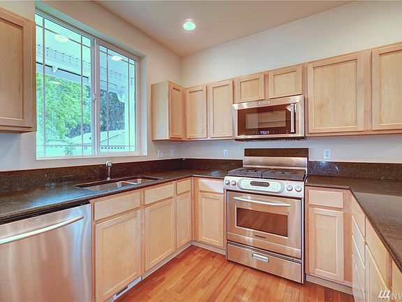 This lovely kitchen boasts of granite countertops and stainless steel appliances.