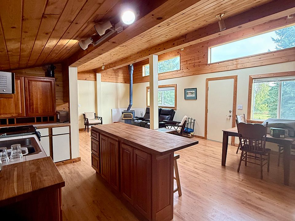 open concept design, Kitchen, dining room. living room with wood burning stove.